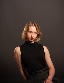 Studio portrait of a young woman in black, conveying elegance and sophistication.
