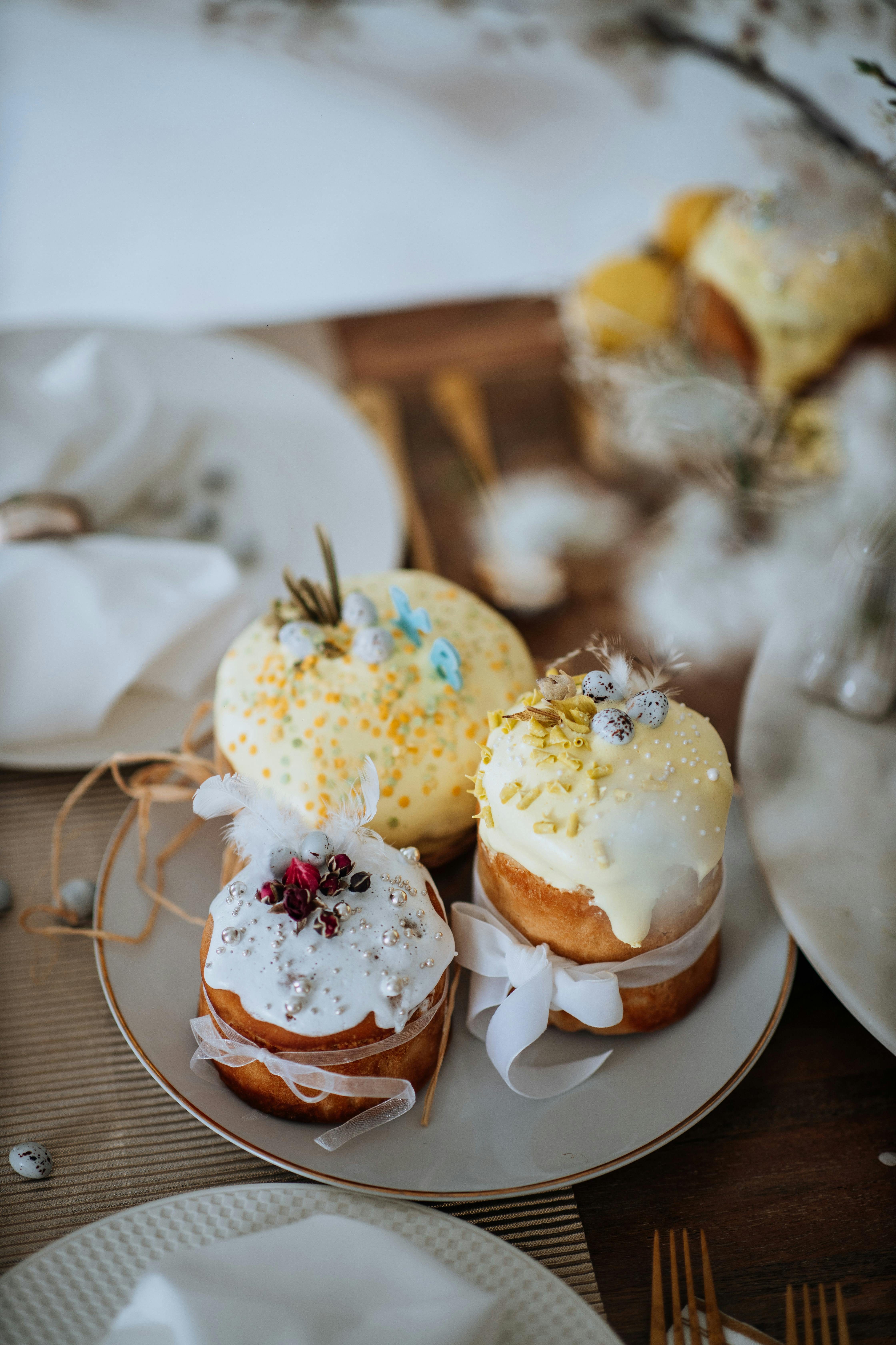 Decorative Easter cakes with icing on a rustic table setting. Perfect for holiday celebrations.