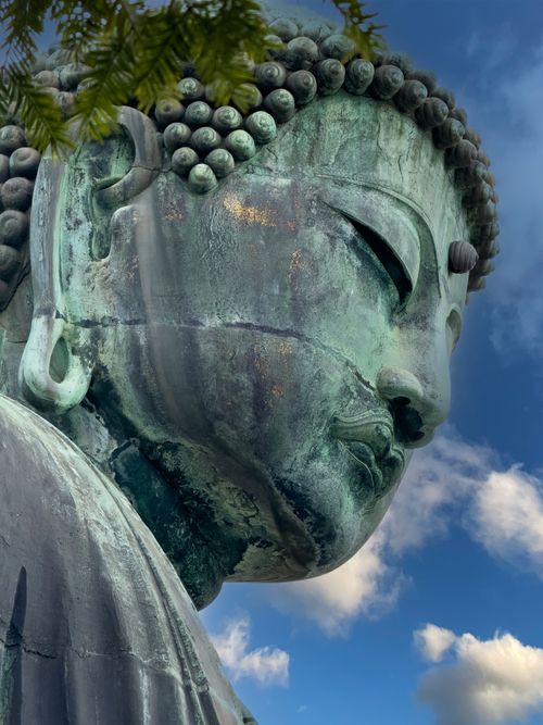 Free Close-up of the Great Buddha statue in Kamakura, Japan, with a vibrant blue sky backdrop. Stock Photo