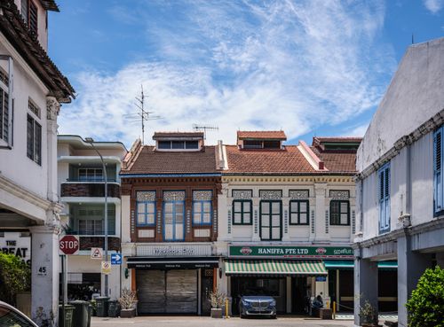Free Traditional shophouses under a vibrant sky, depicting Singapore's cultural architecture. Stock Photo