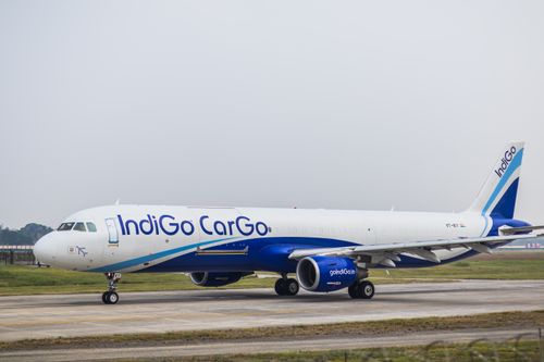 Free Side view of an IndiGo Cargo airplane on an airport runway during daytime. Stock Photo