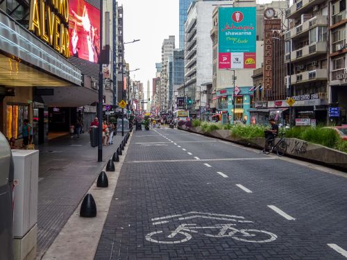 Free Vibrant street view in Buenos Aires featuring shops, signs, and city life on a lively day. Stock Photo