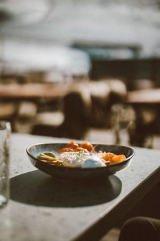 A gourmet dish on a table at an outdoor cafe in Almaty, showcasing vibrant colors in a relaxed setting.