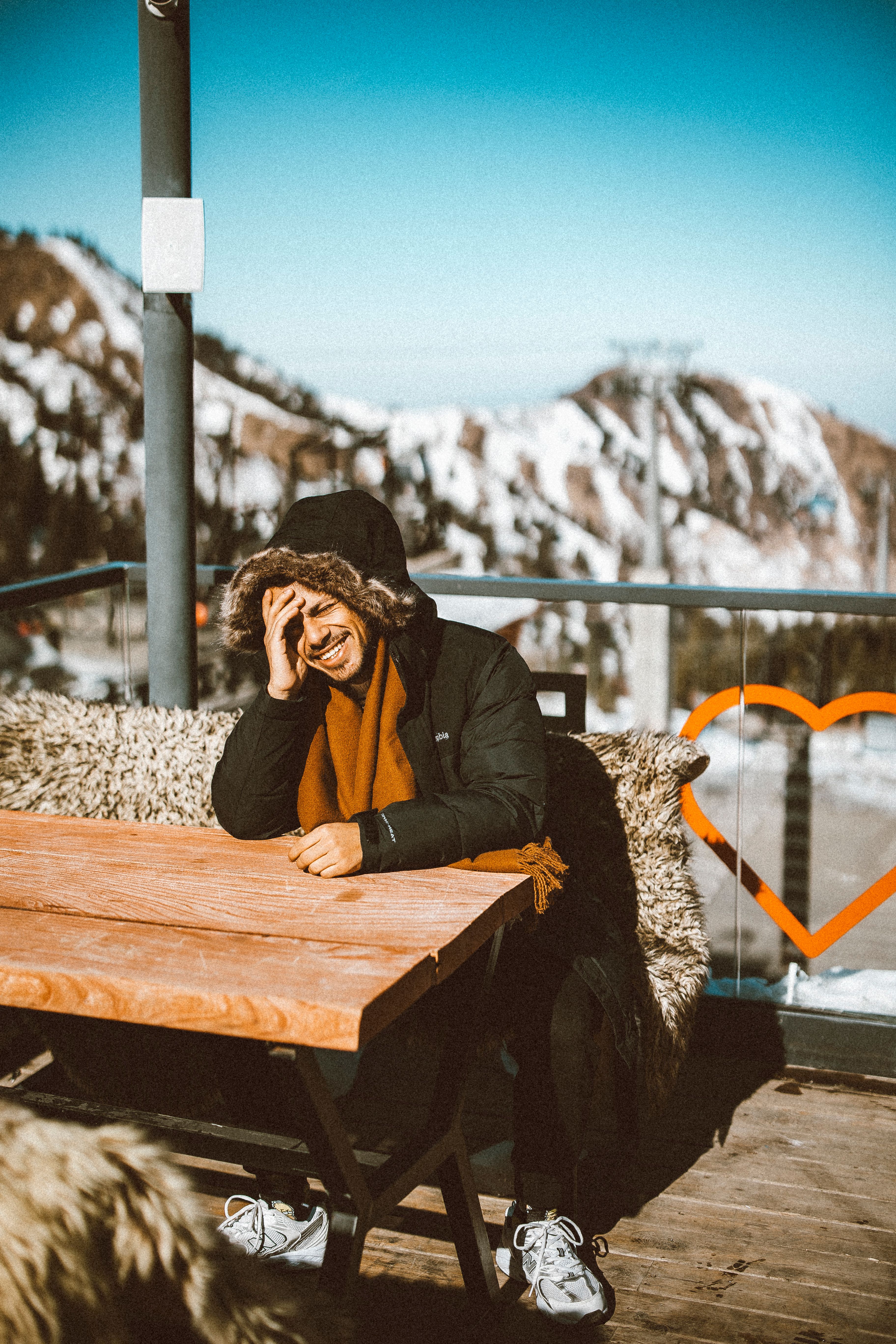 Man enjoying a sunny winter day on a mountain terrace in Almaty, Kazakhstan.