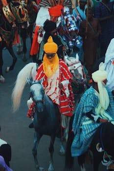 Colorful festival parade featuring traditional attire and horse riders in Nigeria.
