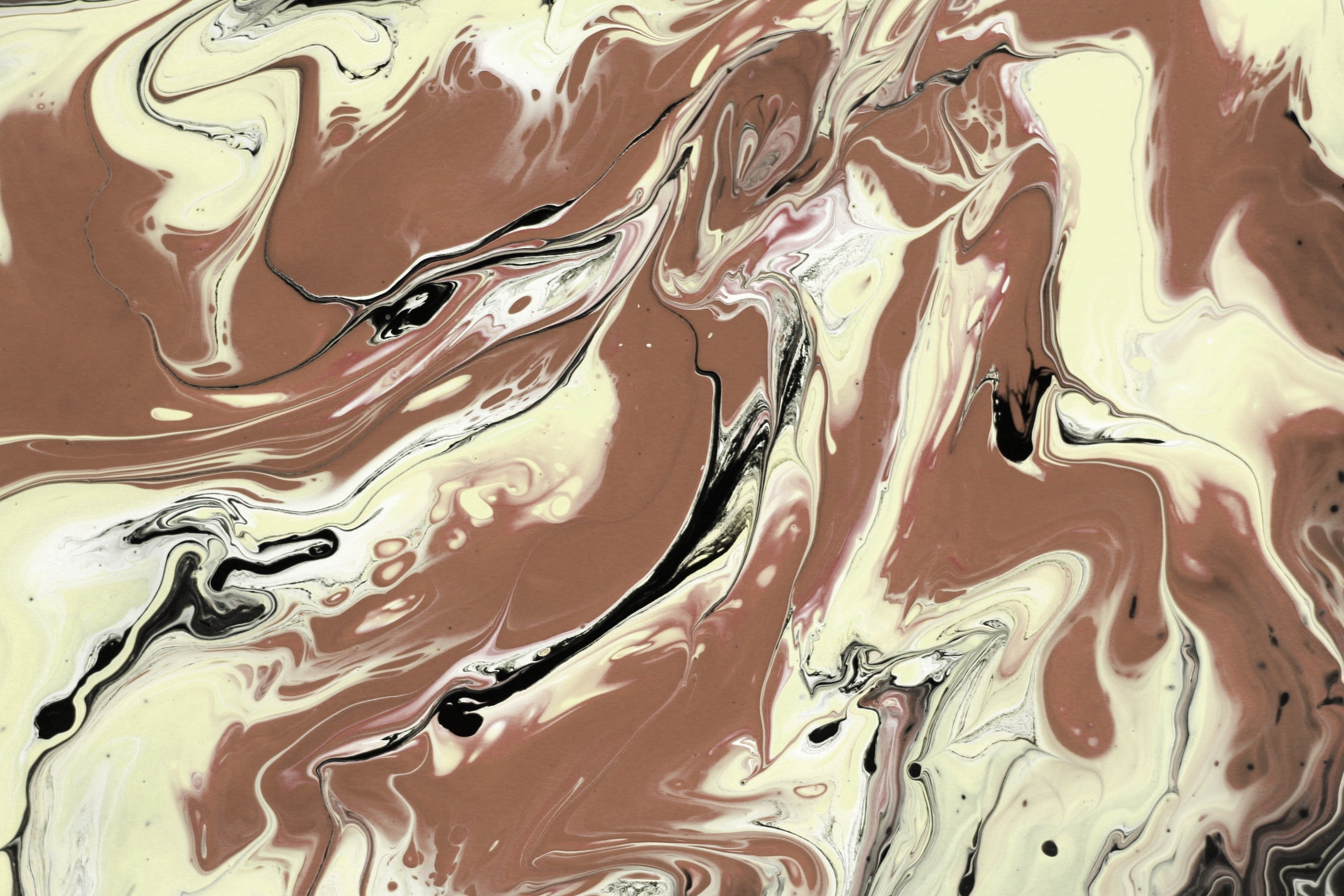 A swirling abstract design featuring marbled patterns in earthy brown and creamy tones.