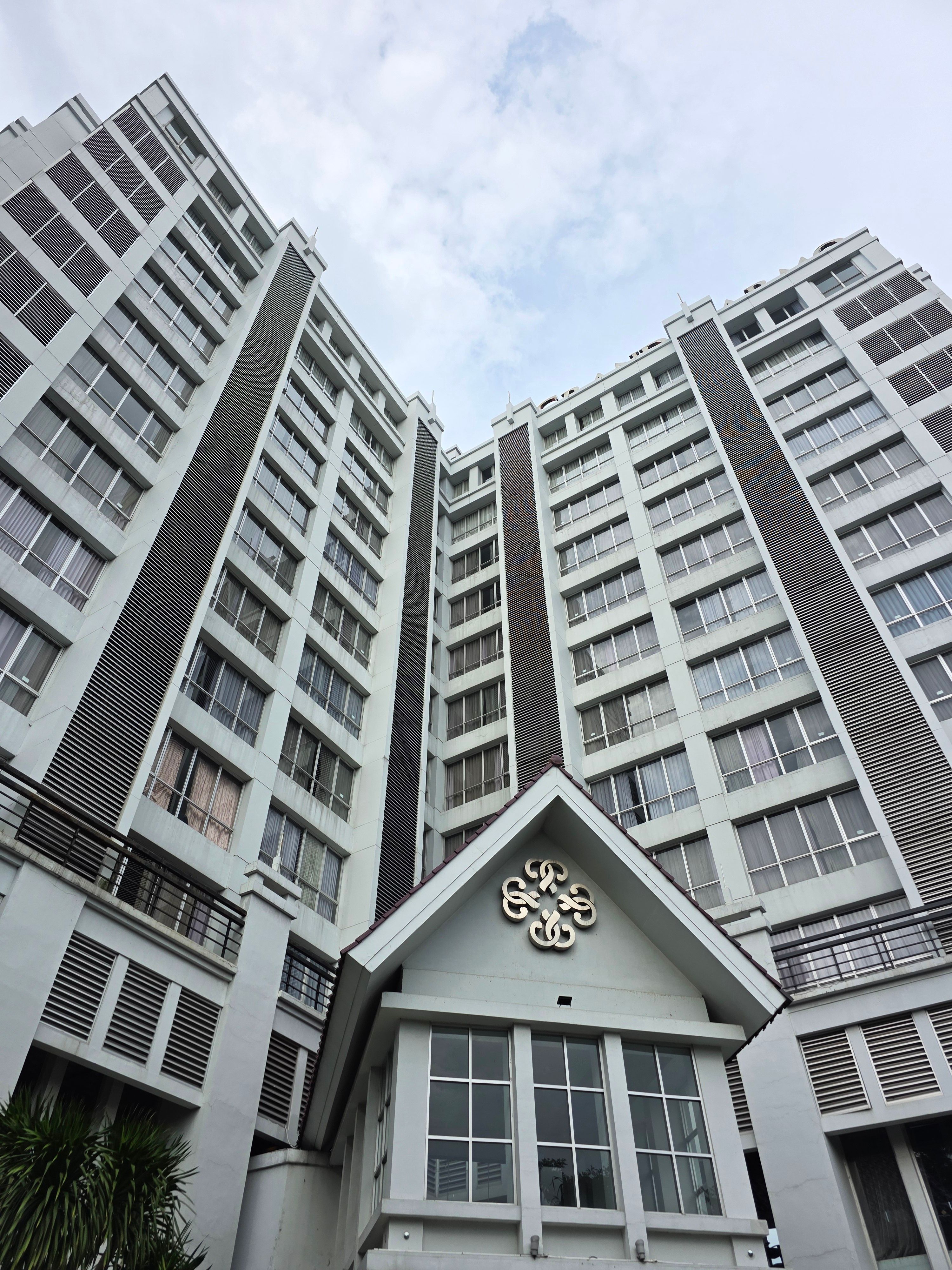 Modern High-Rise Building with Cloudy Sky · Free Stock Photo