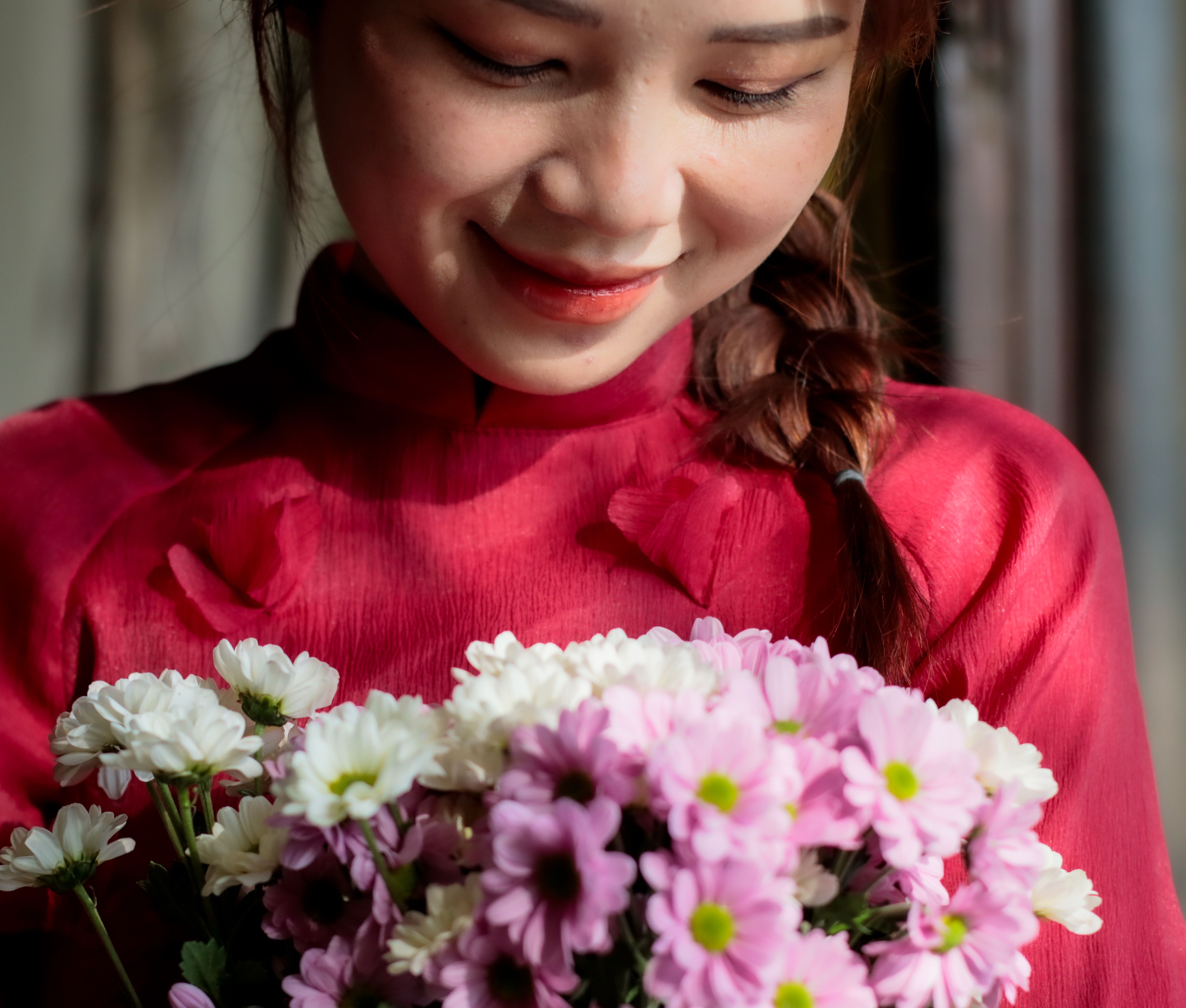 Young Woman in Traditional Dress Holding Flowers · Free Stock Photo