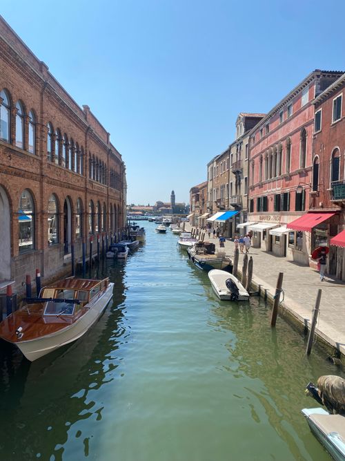 Free Explore a sunny Venetian canal with colorful buildings and boats, perfect for travel inspiration. Stock Photo