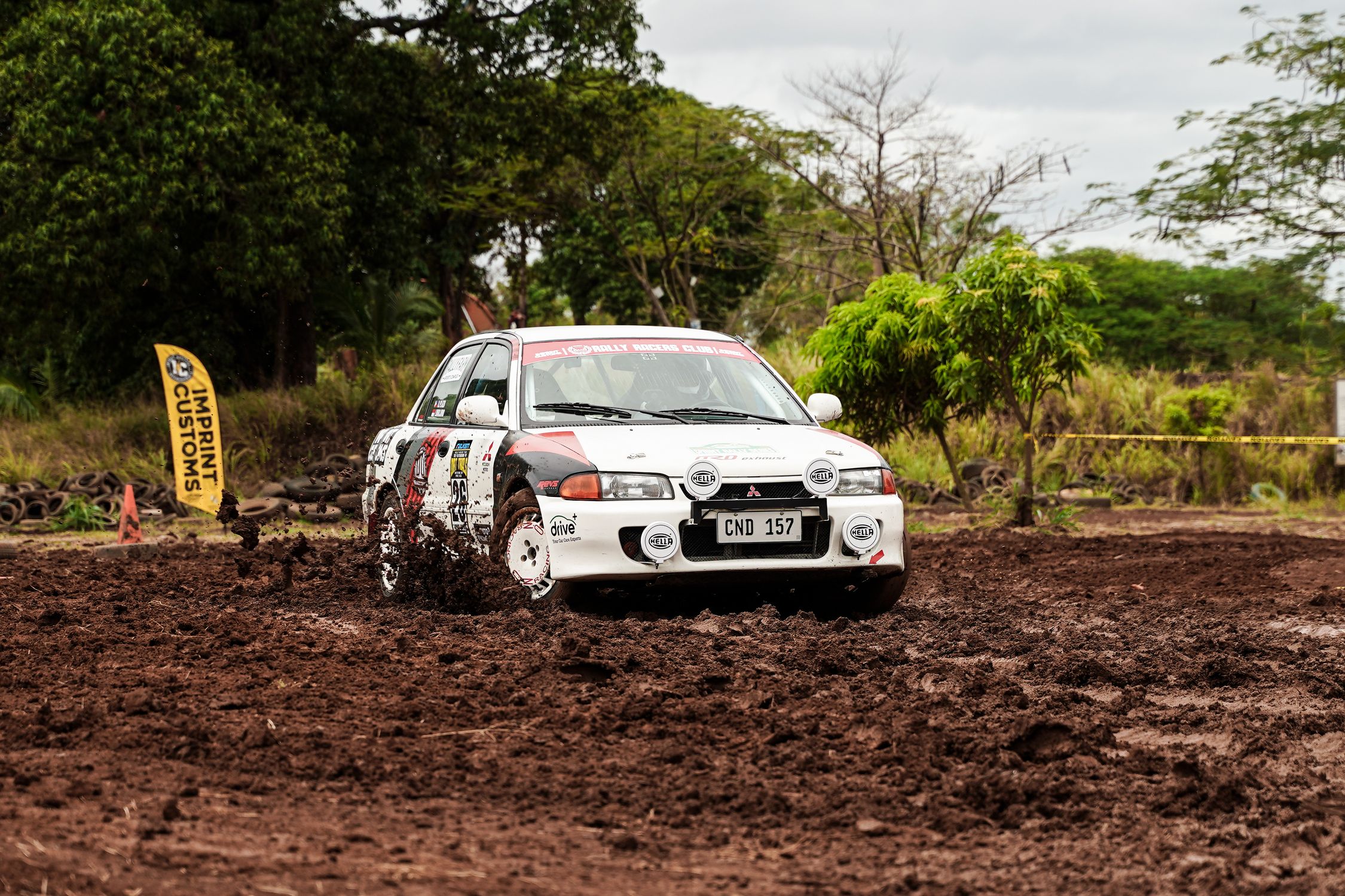 Muddy Rally Car Rear View Dynamic Rally Car Racing Through Muddy Track · Free Stock Photo