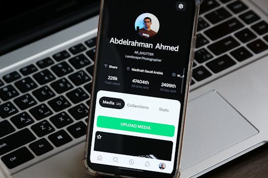 Close-up of a smartphone showing a photographer's profile on a laptop background.