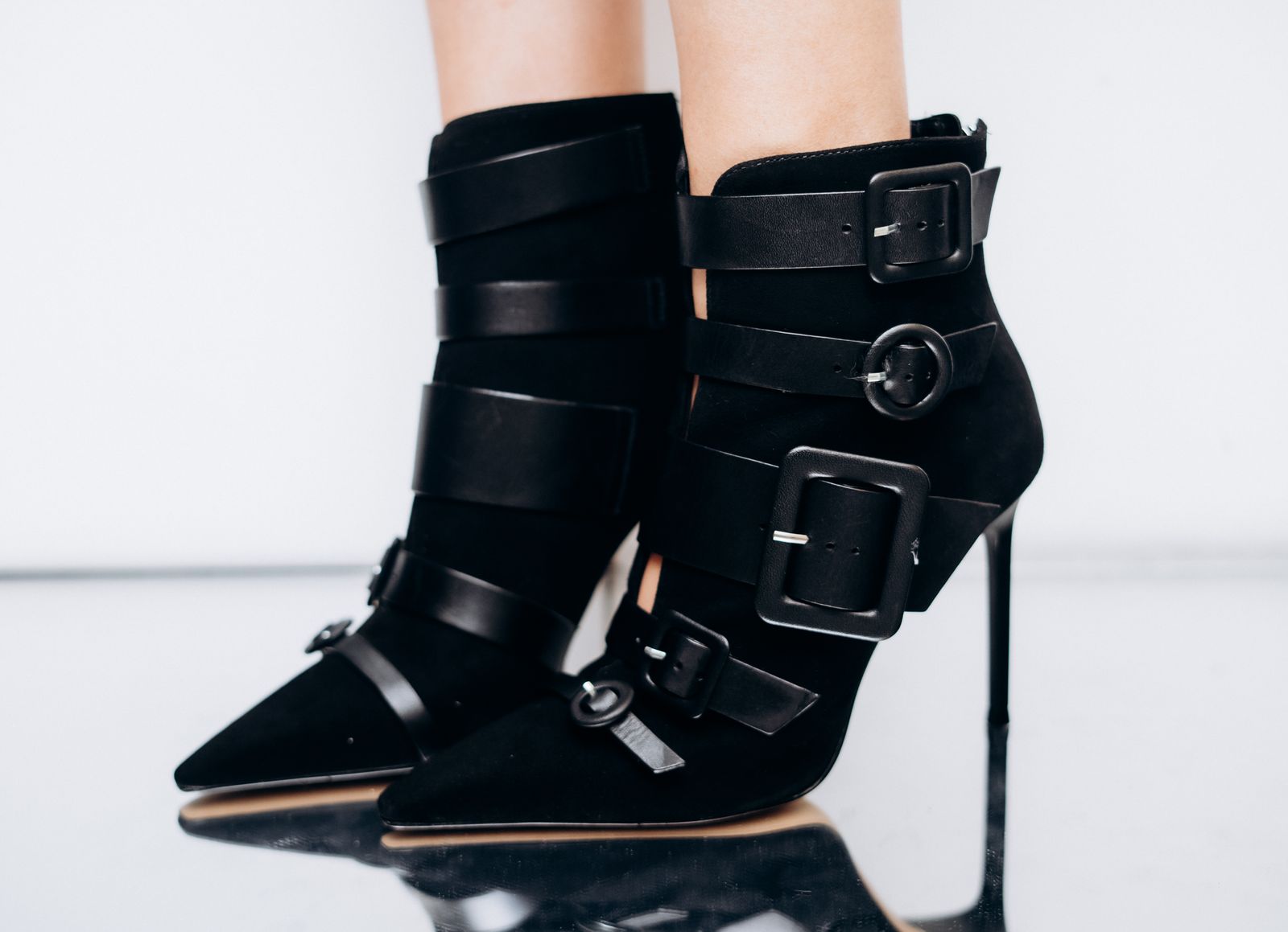 Black heeled boots with straps and buckles