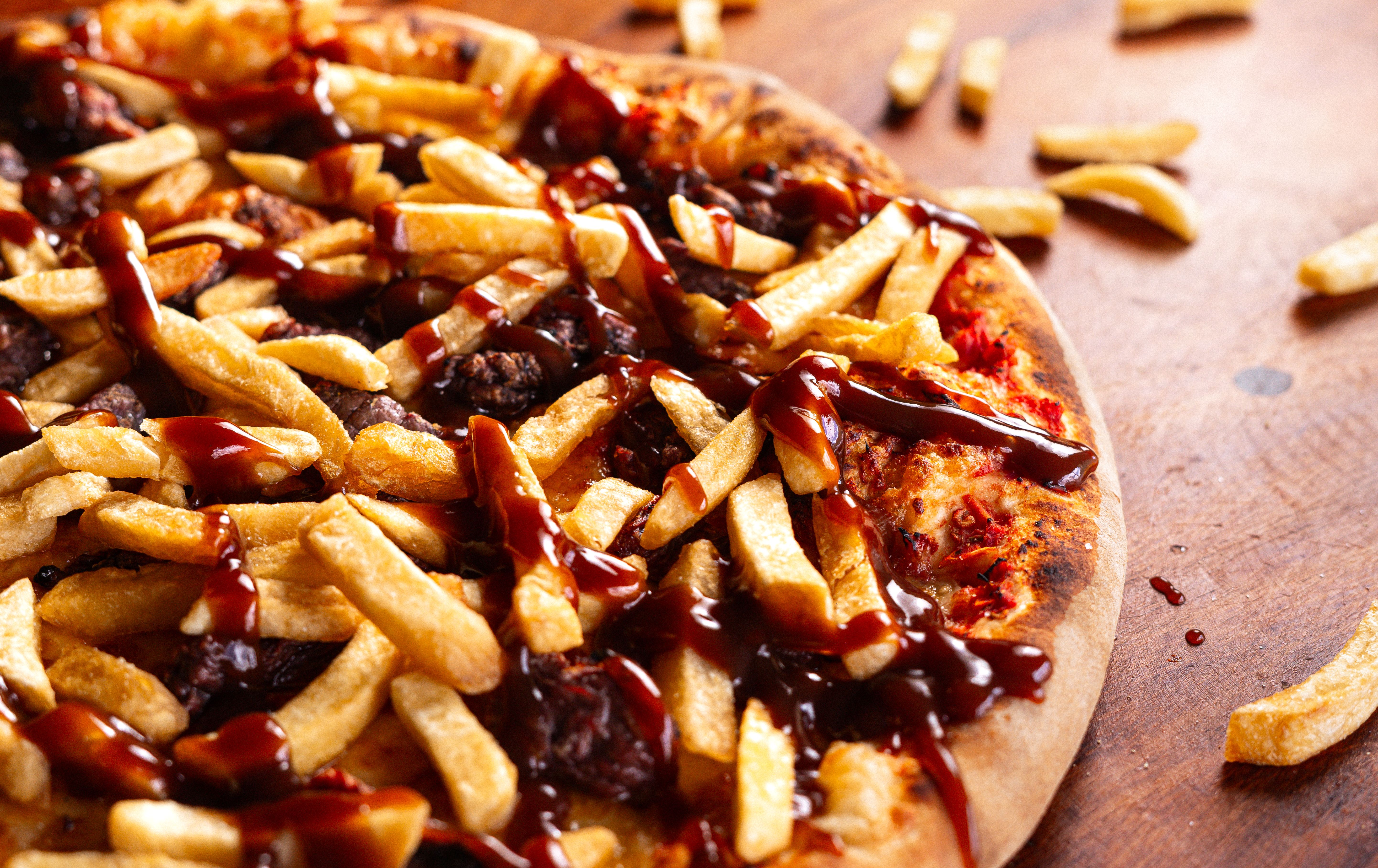 Various unique pizzas on wooden serving boards showing different toppings