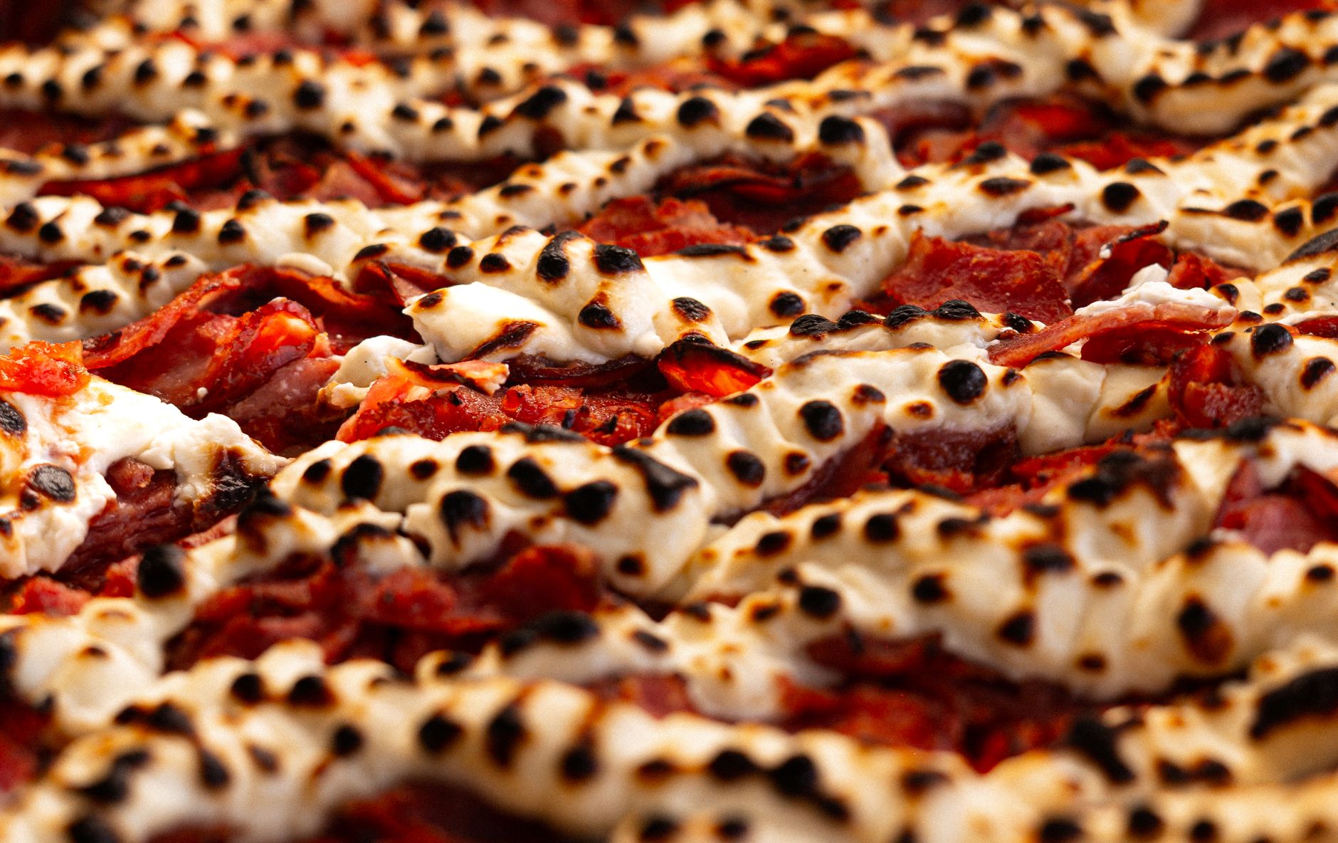 Pepperoni pizza rolls being prepared on a wooden board