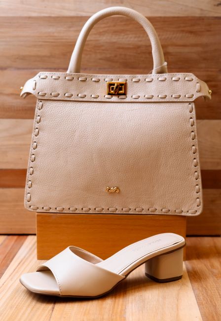 Stylish beige handbag and block heel shoe elegantly displayed on wood, perfect for fashion enthusiasts. - Factors to Consider When Choosing a Handbag