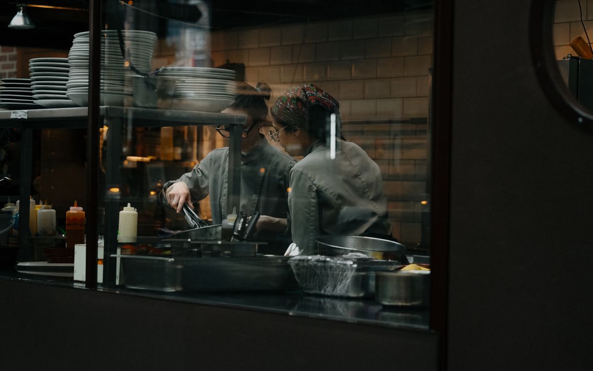 Candid shot of chefs cooking in a restaurant kitchen in Amsterdam.