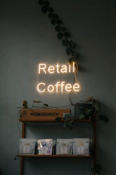 Cozy coffee shop setup with neon sign and retail display in Amsterdam.
