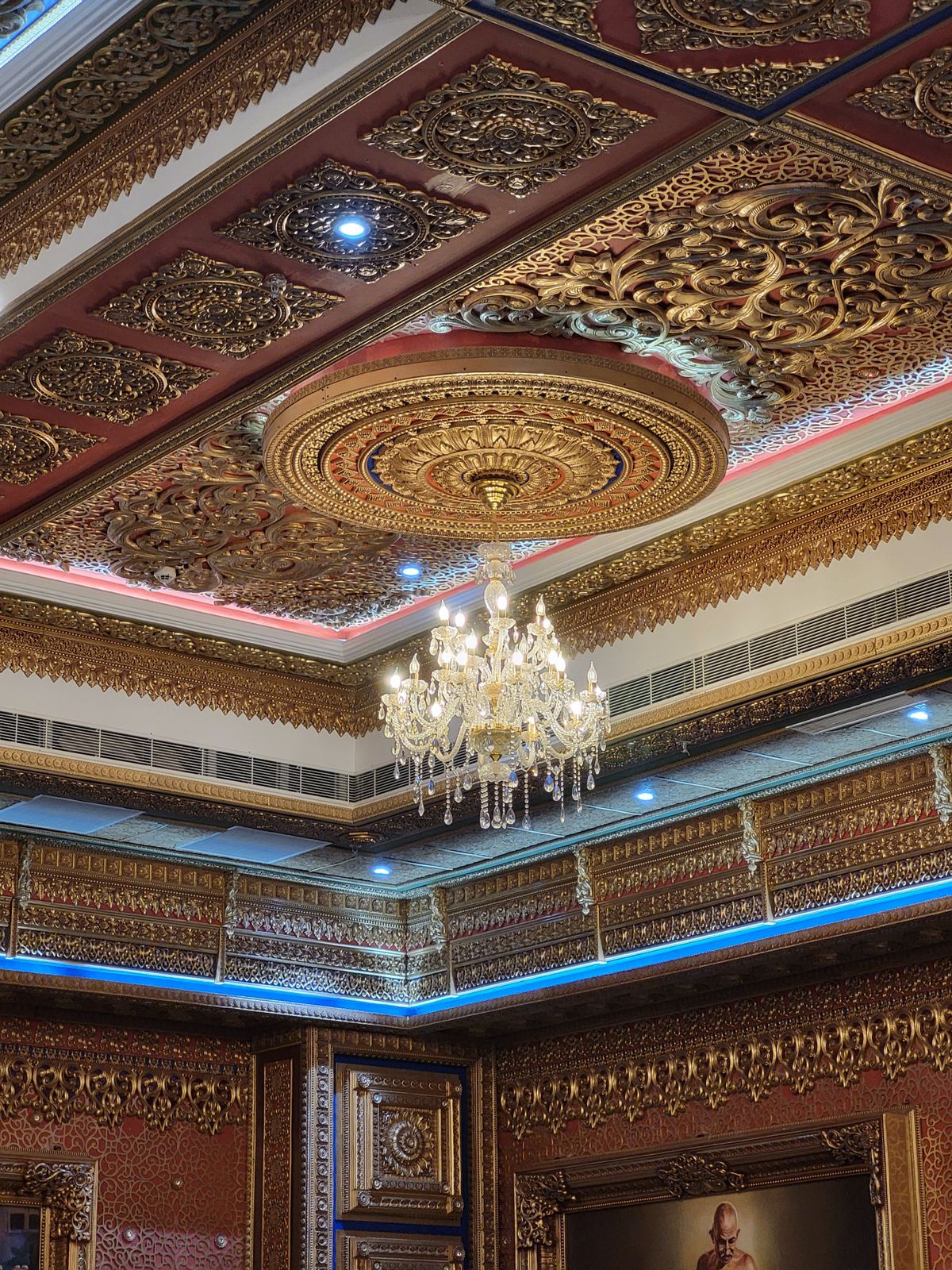 Latest hall false ceiling design with cove lighting and a central chandelier