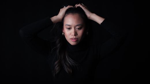 A woman in a black turtleneck in low light — photo by Bastian Riccardi on Pexels