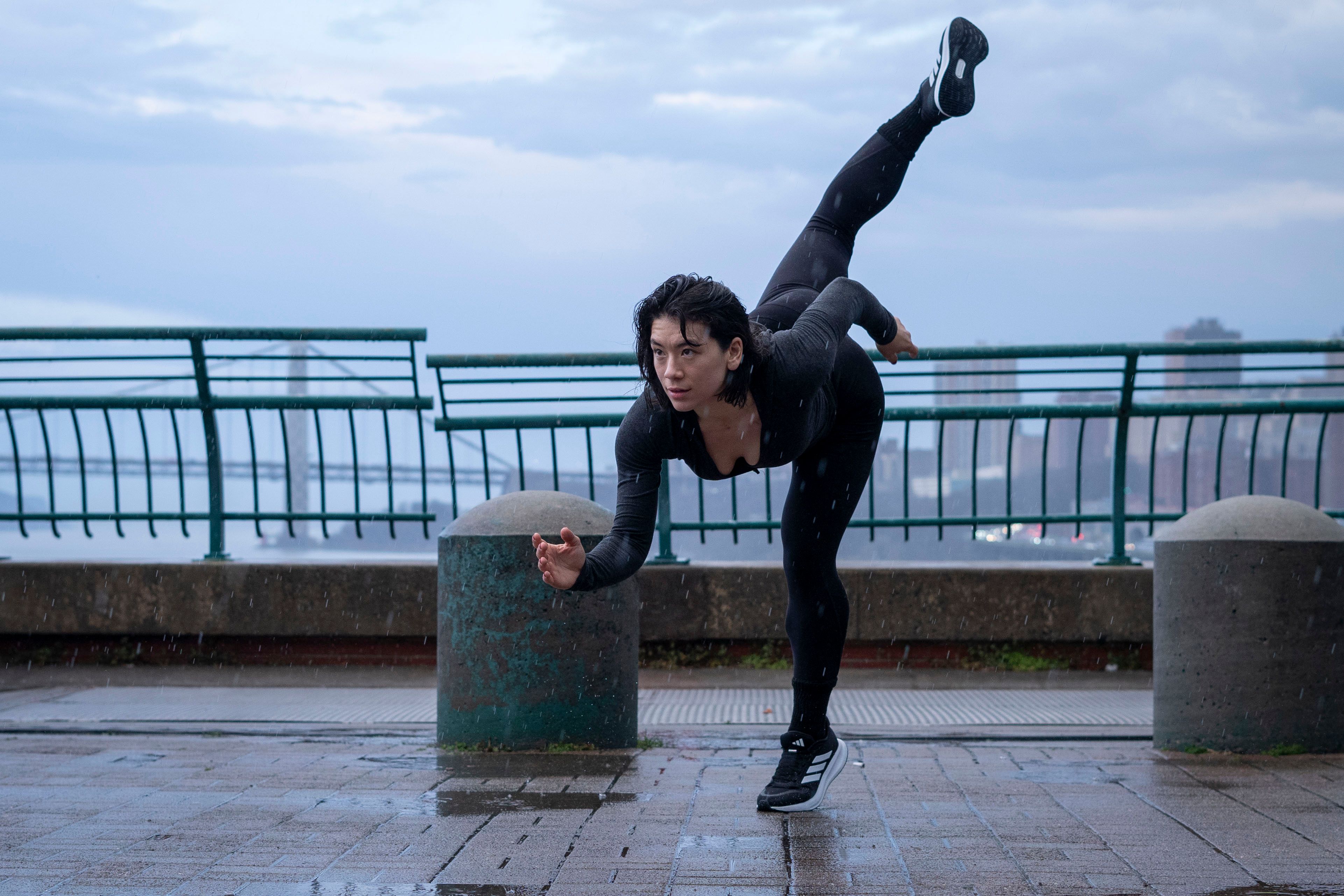 Dynamic Pose by a Waterfront in Urban Setting · Free Stock Photo