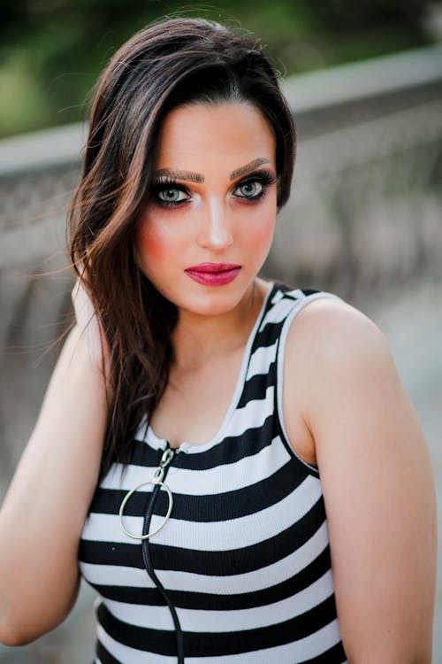 Woman in Black and White Striped Top