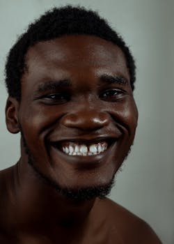 Close-up portrait of a smiling young man in Minna, Nigeria, showcasing genuine joy.