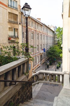 Discover a quaint Parisian street with historic architecture and lush greenery, capturing the essence of Île-de-France.