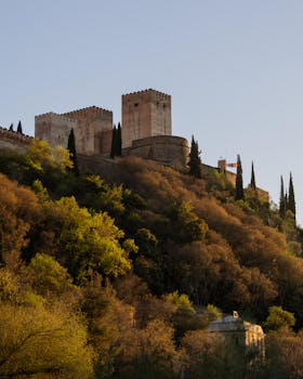 Stunning view of the Alhambra Palace surrounded by lush greenery in Granada, Spain.