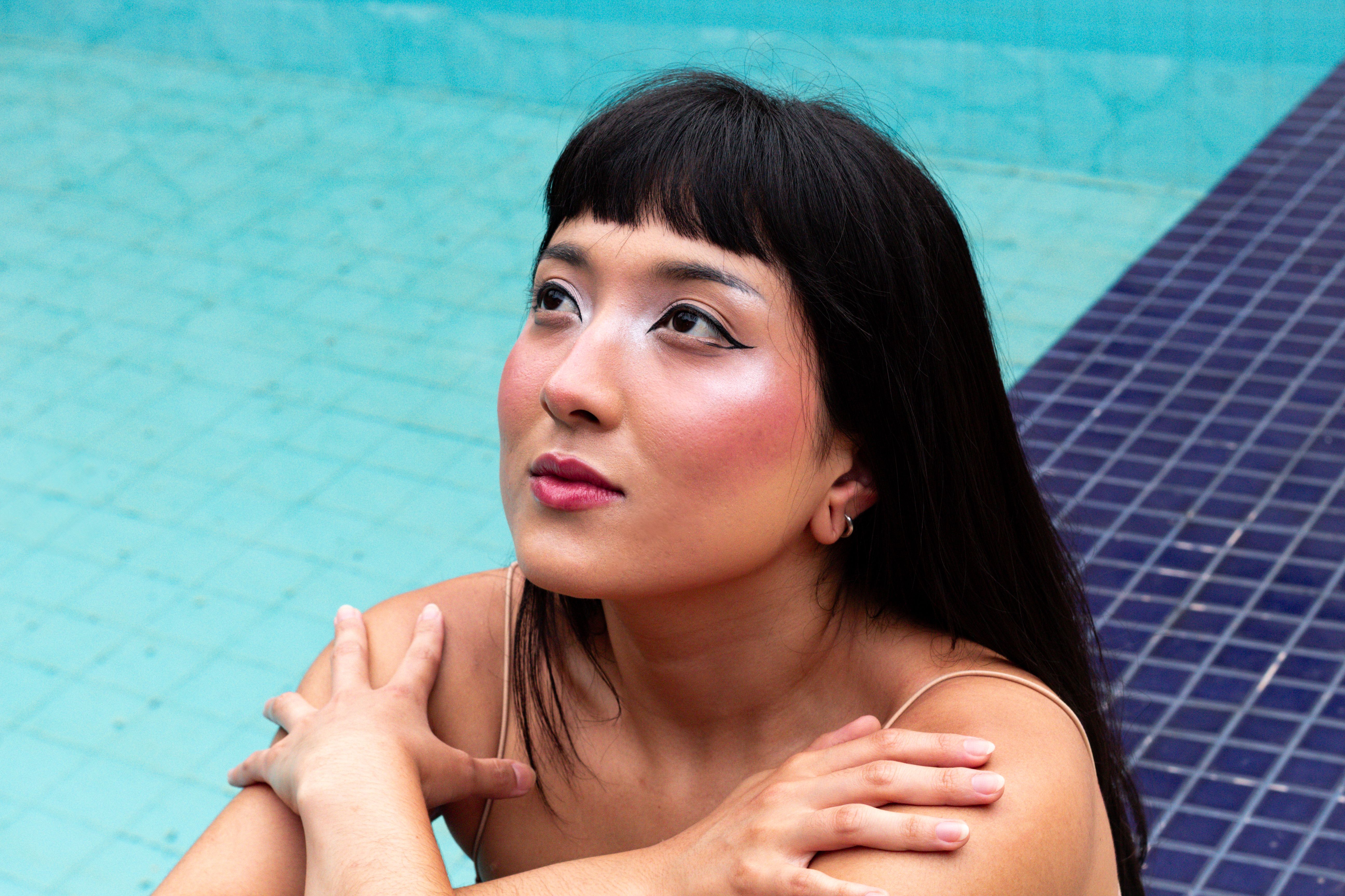 Elegant Woman with Makeup by Poolside · Free Stock Photo