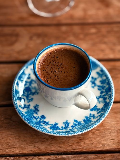 Free Aromatic Turkish coffee served in a classic blue-patterned cup on a wooden surface. Stock Photo