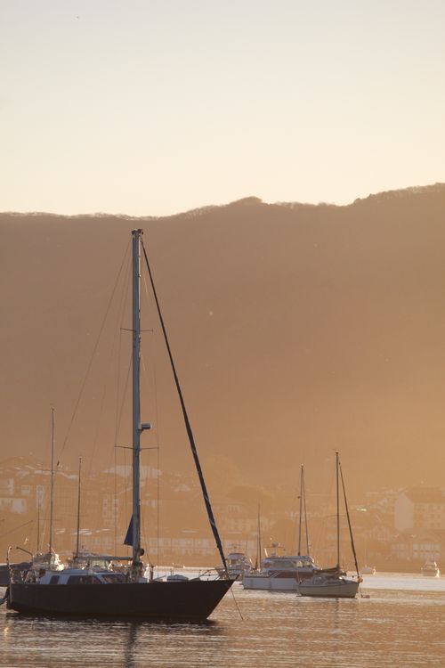 Free Sunset view of sailboats at Hondarribia, Spain under a golden sky. Stock Photo