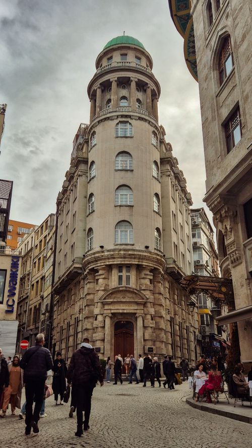 Free Elegant historic building in a lively Istanbul street scene with people and classic architecture. Stock Photo