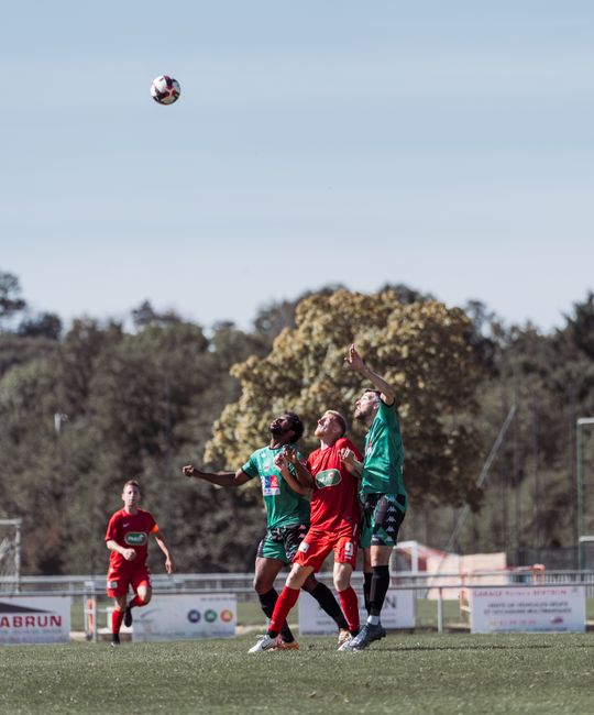 soccer player defending aerial duel