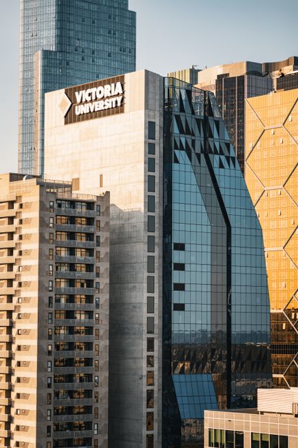 Cityscape featuring Victoria University building in downtown city skyline during daylight.