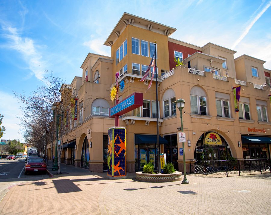 Outdoor shopping center with storefronts and pedestrian walkway