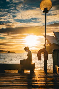 Peaceful sunrise at Sydney waterfront with Opera House view.