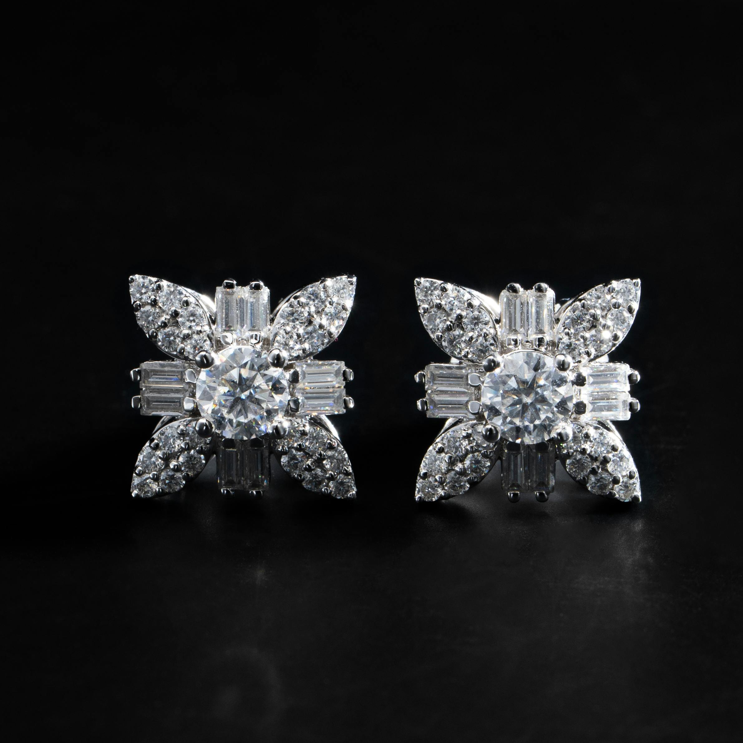 Diamond stud earrings on black background (Pexels)