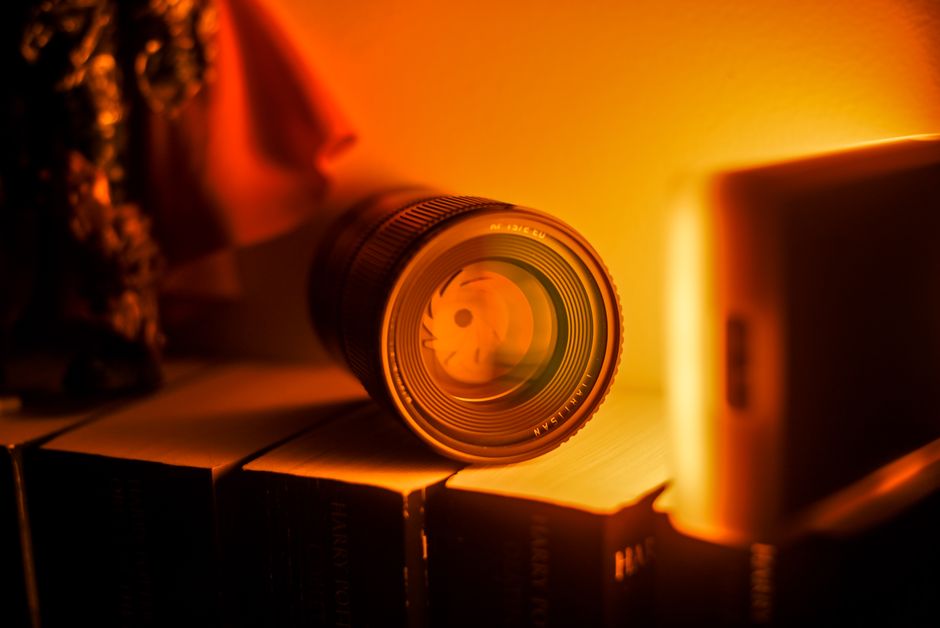 Camera lens alongside books illustrating vision and language fused into one model