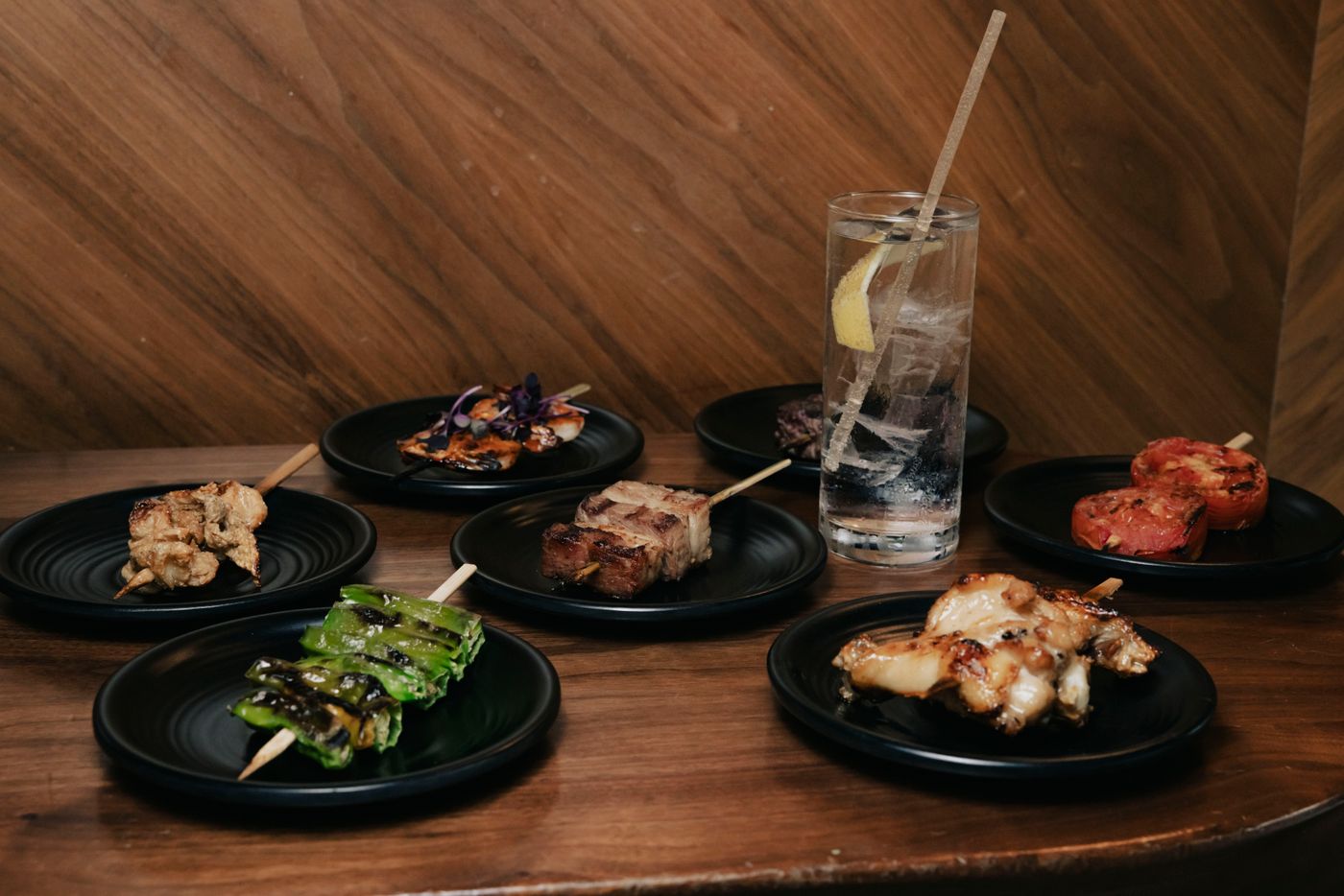 A delectable array of grilled skewers with refreshing cocktail on a cozy restaurant table.