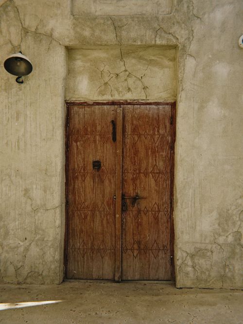 Free An ornate wooden door with Islamic design elements in Old Dubai, UAE. Stock Photo