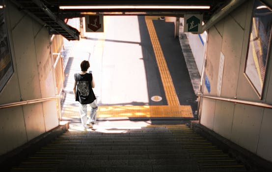 A person descending stairs at a Tokyo station, showcasing urban life.
