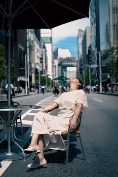 A woman enjoys a sunny day in Ginza, Tokyo, relaxing in a street cafe.