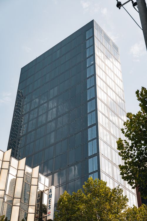 Free A sleek, modern skyscraper in the heart of Melbourne, Australia, against a clear sky. Stock Photo