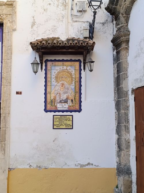Free Intricate religious tile artwork on a historic building wall in El Puerto de Santa María, Spain. Stock Photo