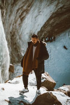 A man trekking in a snowy canyon in Almaty, showcasing winter adventure travel.