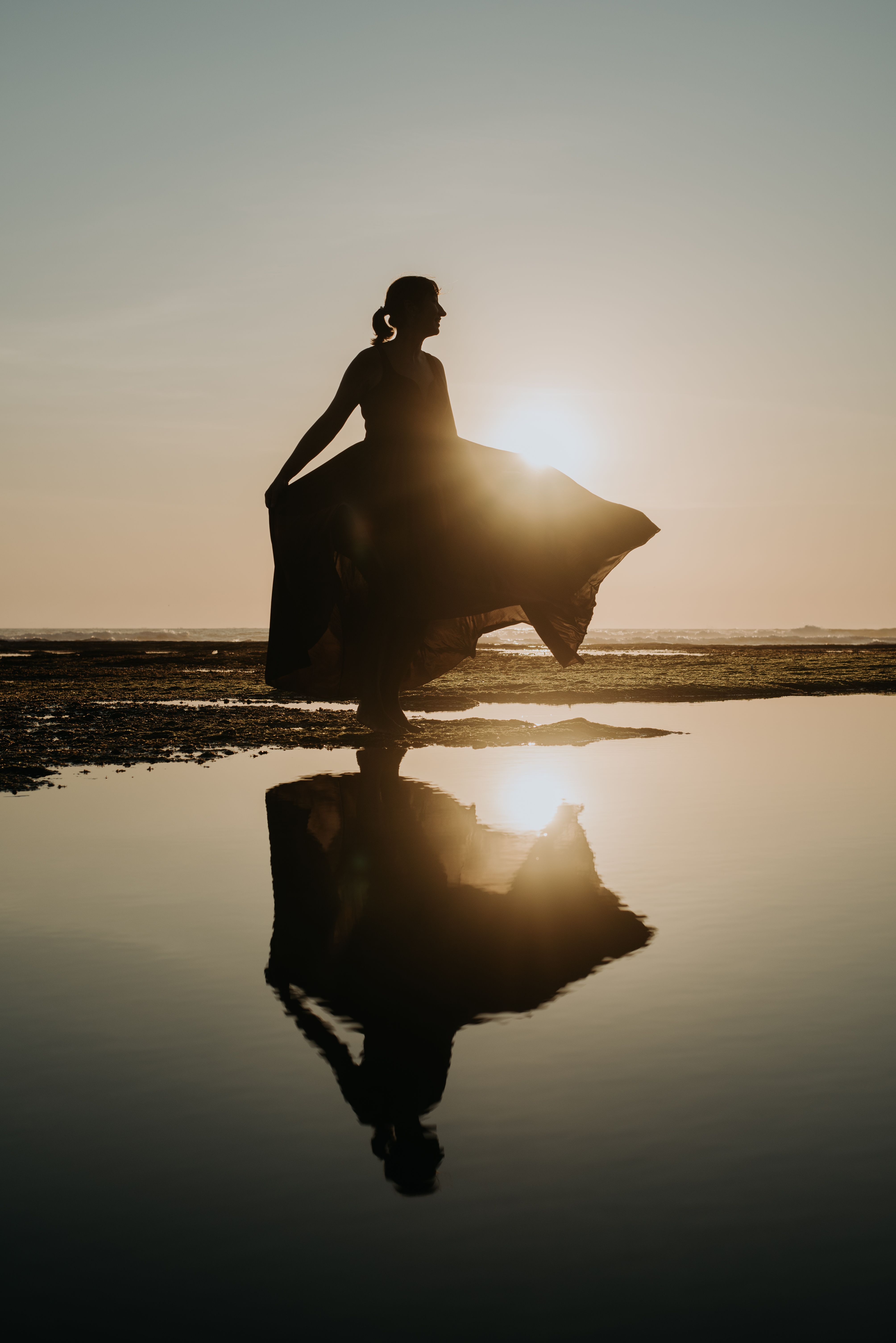 Silhouette of Woman by the Sea at Sunset · Free Stock Photo