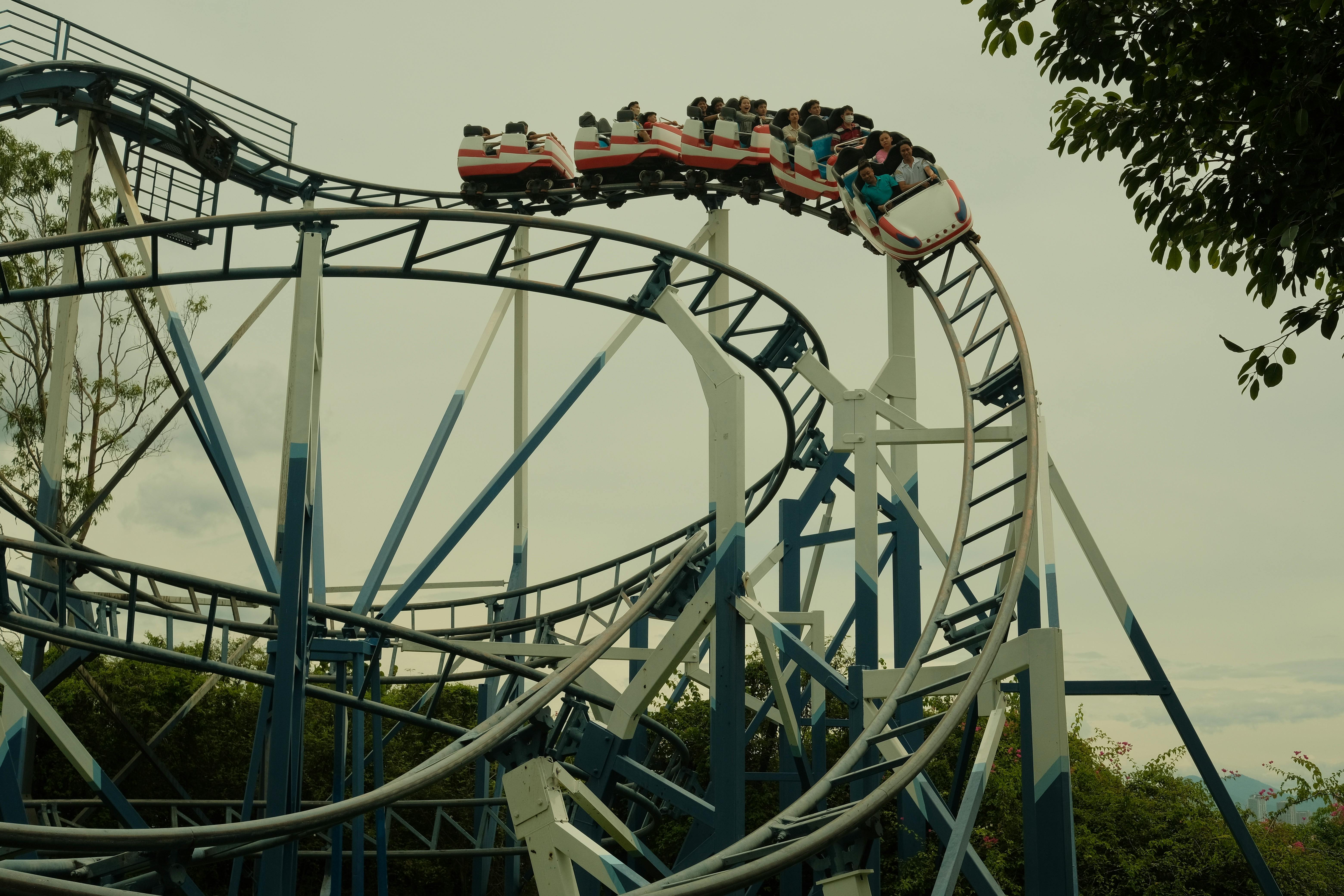 Thrilling roller coaster ride in an outdoor amusement park setting during the day.