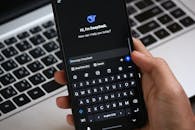 Person Holding Smartphone with AI Chat Interface