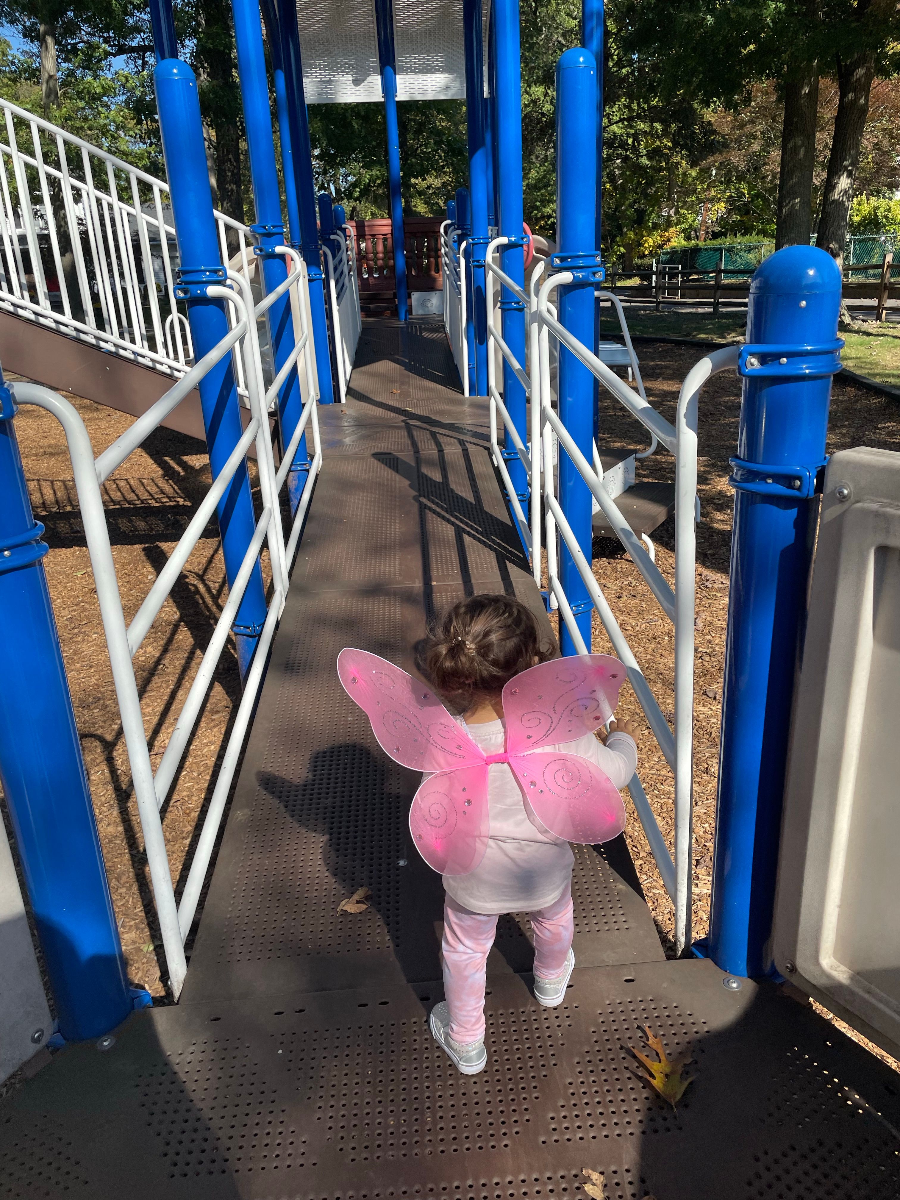 Child with Pink Wings on Playground Ramp · Free Stock Photo