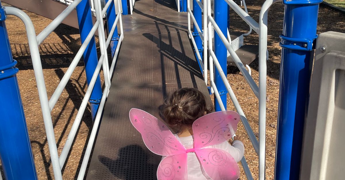 Pink Ramp Child with Pink Wings on Playground Ramp ยท Free Stock Photo